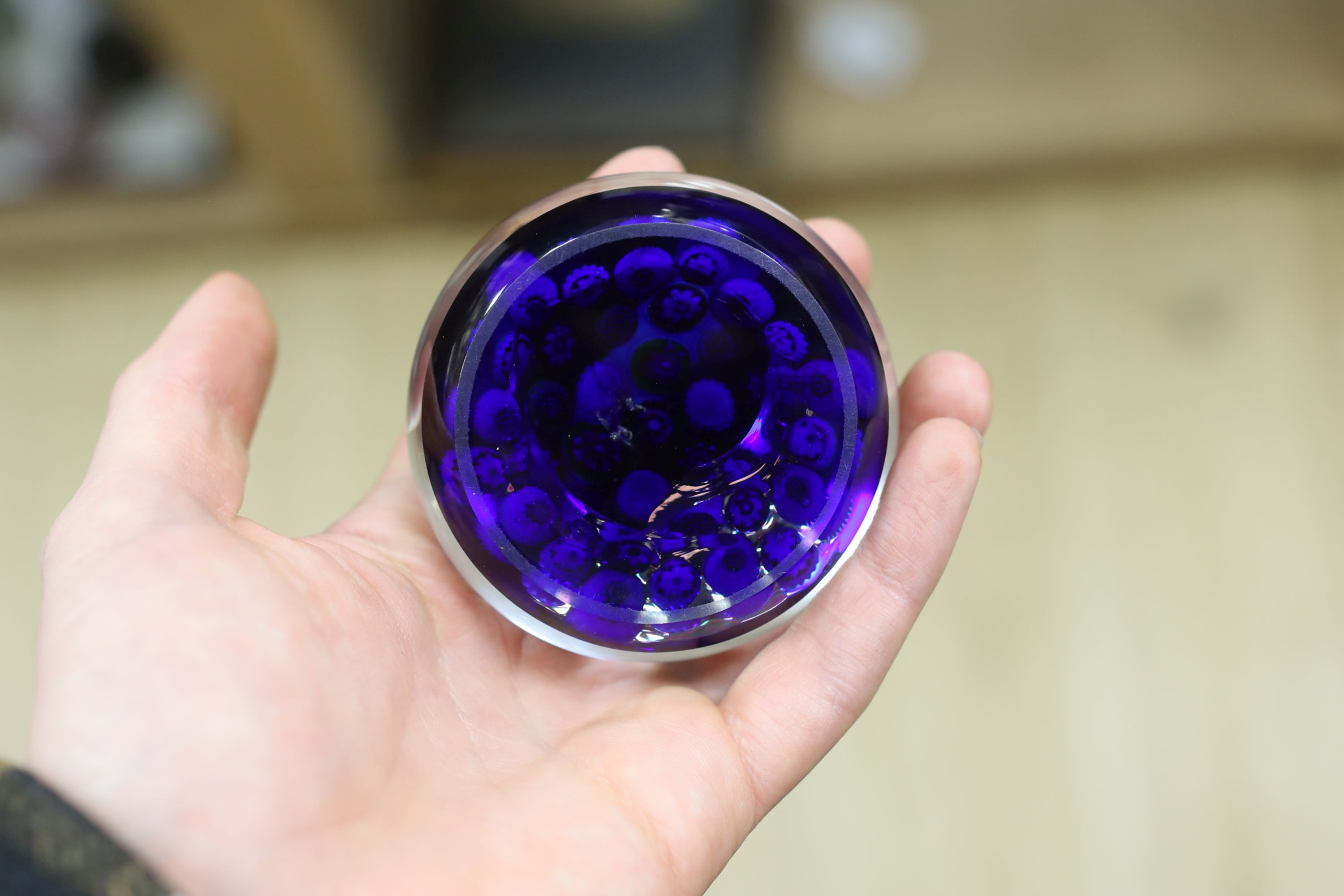 A Clichy translucent blue ground millefiori glass paperweight, 7cm in diameter